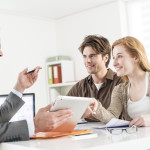 Realtor helping clients at a table