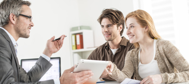 Realtor helping clients at a table